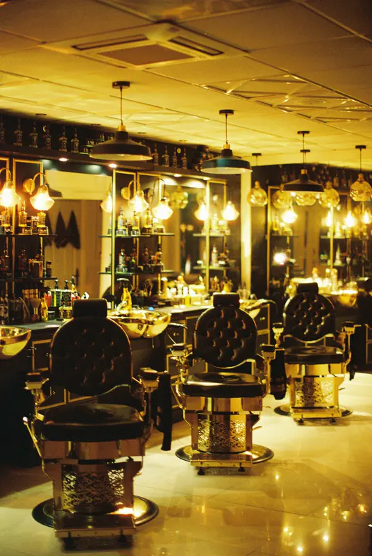 Dunkler Salon mit Ledersesseln, Kupferbecken und warmen Glühlampen